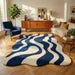 Wavy Modern Blue & Cream Area Rug – Handcrafted Abstract Curved Rug